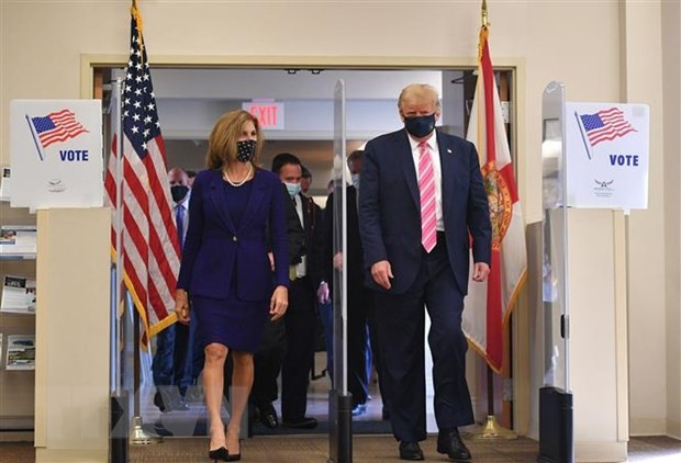 Tổng thống Mỹ đương nhiệm Donald Trump (phải) rời thư viện Palm Beach, Florida, nơi ông bỏ phiếu sớm trong cuộc bầu cử Tổng thống, ngày 24/10/2020. (Ảnh: AFP/TTXVN)